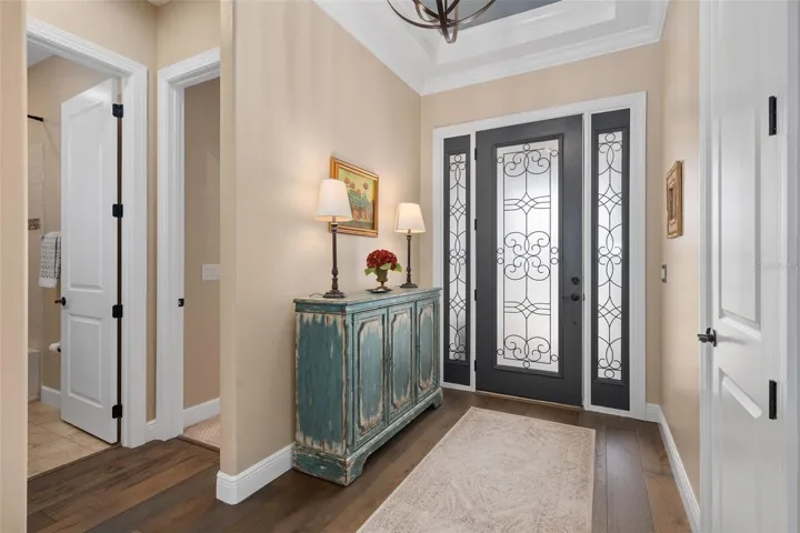 A Grande Foyer with a Tray Ceiling and a Coat Closet