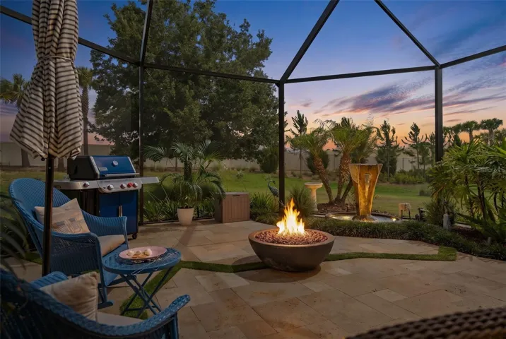 A Beautiful Screened Lanai Extension featuring Travertine Floors, Firepit and a Fountain.