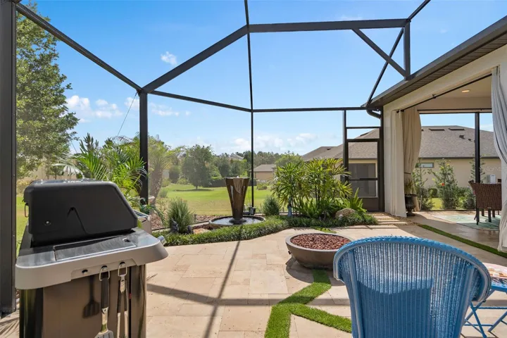 A Beautiful Screened Lanai Extension featuring Travertine Floors, Firepit and a Fountain.
