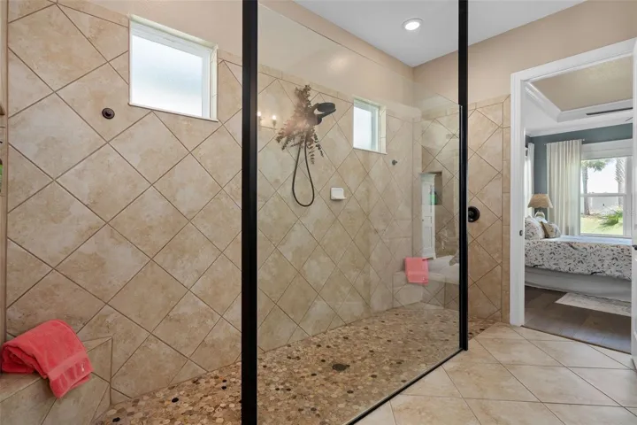 Primary En-Suite Shower with a Corner Seat.