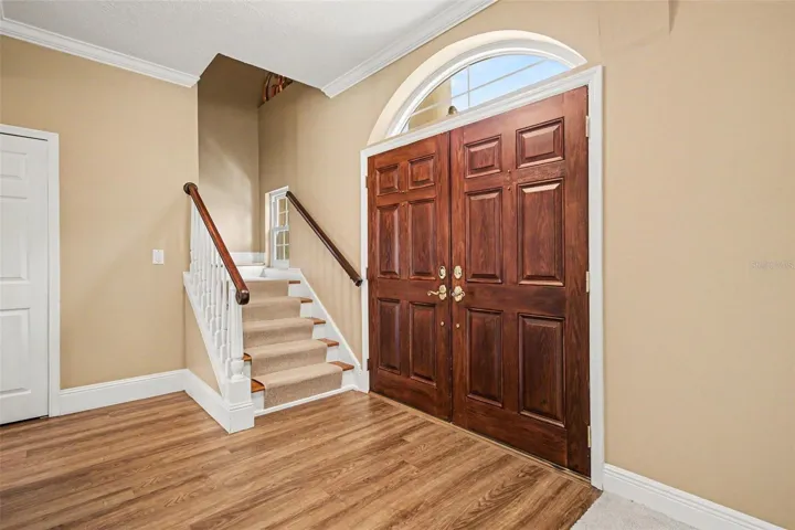 Foyer. Wood Stairs Complete with No Slip Wool Carpet Runner