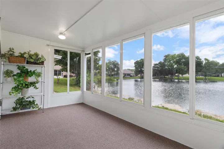 Beautiful Enclosed Lanai with Windows and Screens Overlooking Water
