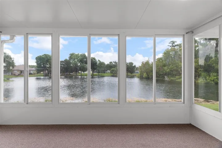 Beautiful Enclosed Lanai with Windows and Screens Overlooking Water