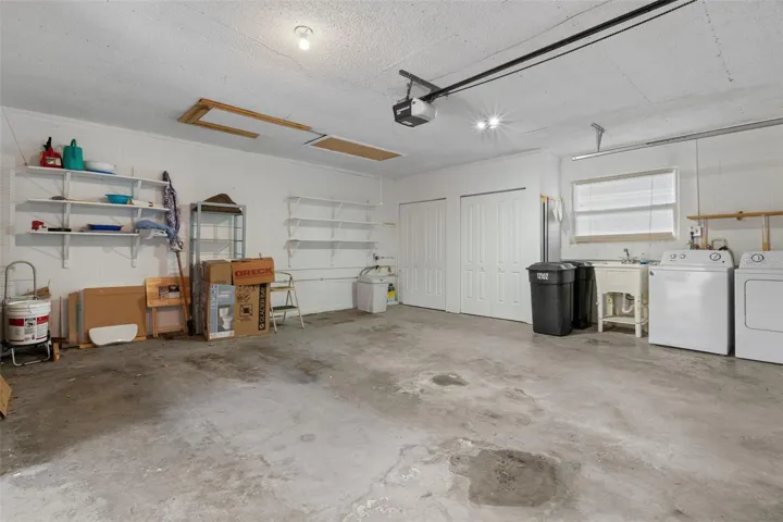 Laundry Area with Storage Closets and Laundry Sink