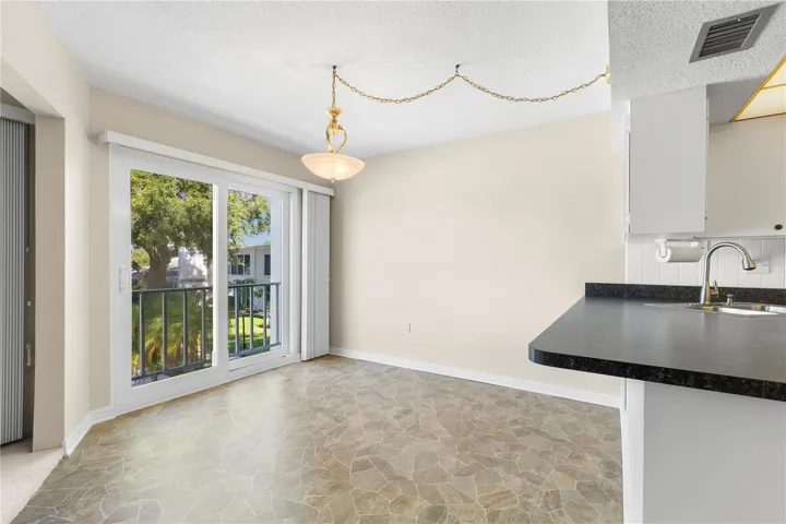 Dining room with impact sliders to balcony overlook