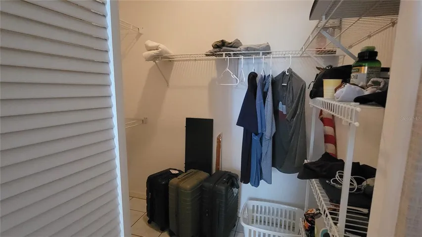 The large walk-in closet is a the back hall of the primary bath suite