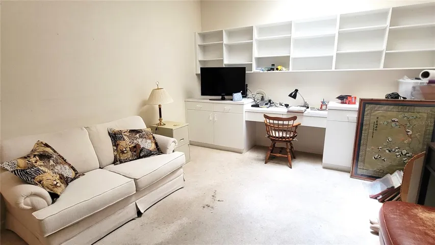 Across from the dining room is the Den/Office with built-in desk and shelves, skylight brings daylight into this room
