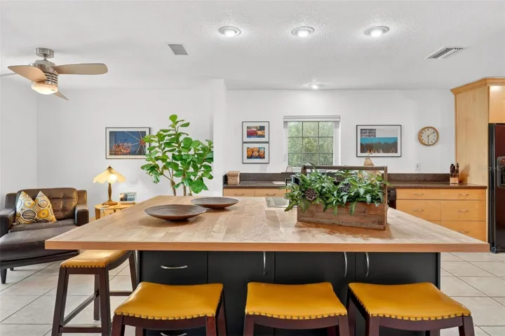 At the heart of the home, this spacious kitchen features an oversized island with a Thermador induction cooktop, creating the perfect place to prepare meals, entertain guests, and stay connected with family and friends in the open-concept living space.