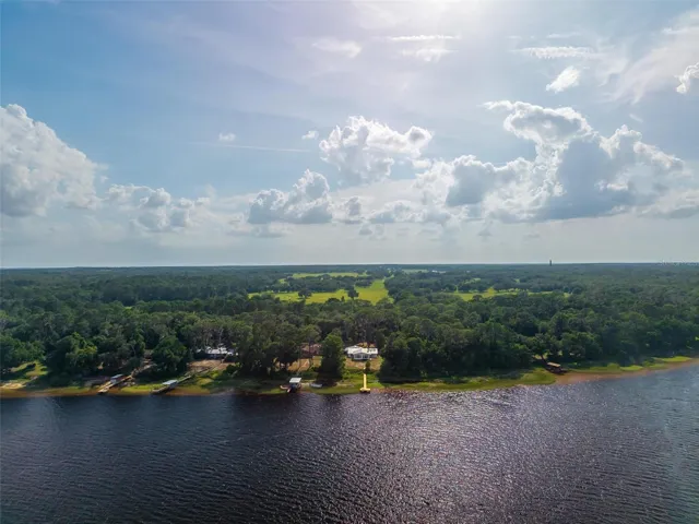 A breathtaking aerial view of Lake Dorr, one of the most beautiful lakes in the Ocala National Forest area, offering wide-open water, peaceful forest surroundings, and an unforgettable connection to natural Florida beauty. Known for its clear, spring-fed waters and scenic shoreline, Lake Dorr creates the perfect backdrop for boating, kayaking, canoeing, fishing, waterskiing, and quiet days on the water. From this view, you can truly appreciate the rare lifestyle this property offers — lakefront living, protected natural beauty, and the feeling of having one of Lake County’s most peaceful retreats right at your doorstep.