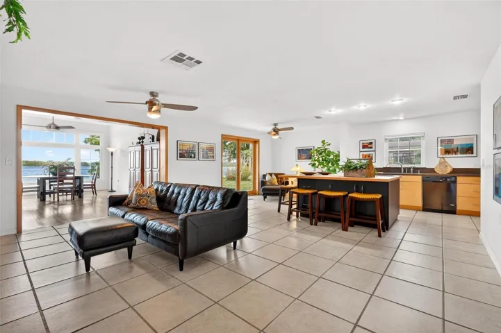 The heart of the home offers an open and comfortable layout where the kitchen, dining, and living areas connect beautifully, creating a welcoming space for family gatherings, entertaining guests, or simply relaxing after a day on the lake.