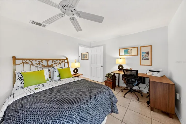 Bright third bedroom with wooded front views, generous closet space, and flexible use for guests, family, or a home office.
