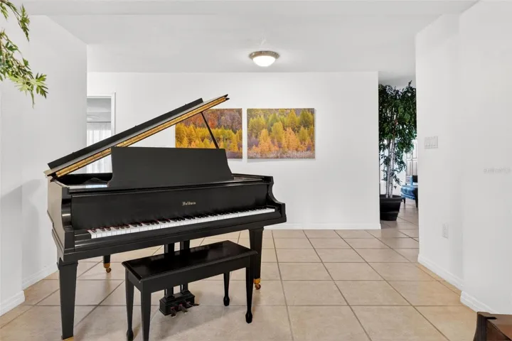 A welcoming foyer opens into the home with bright natural light, clean neutral finishes, and an inviting first impression. From the moment you enter, the space feels open, calm, and connected, setting the tone for the peaceful Lake Dorr retreat beyond.