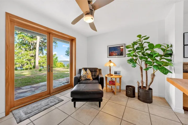 Cozy breakfast nook and seating area with French doors leading toward the lake — the perfect place for coffee, reading, and soaking in peaceful Lake Dorr views.