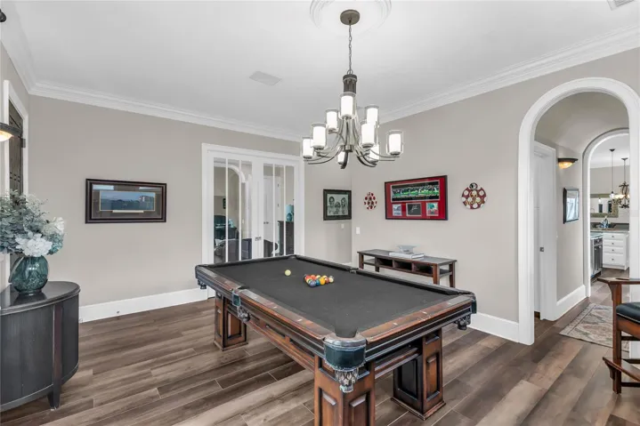 Living room- crown molding, lots of natural light and arched doorways!