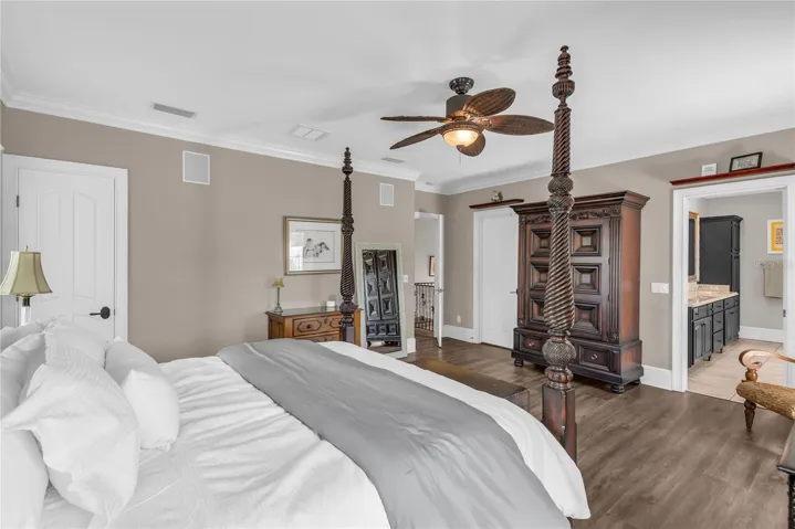 Huge primary suite with a walk-in closet plus an additional closet, private balcony overlooking the pool and spacious en suite bathroom