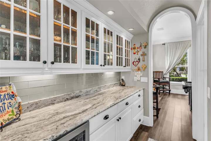 Butler's pantry with lots of storage and wine fridge