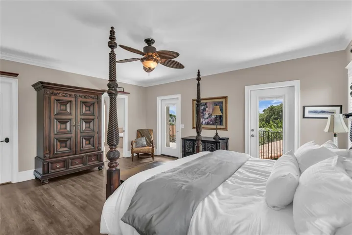 Huge primary suite with a walk-in closet plus an additional closet, private balcony overlooking the pool and spacious en suite bathroom