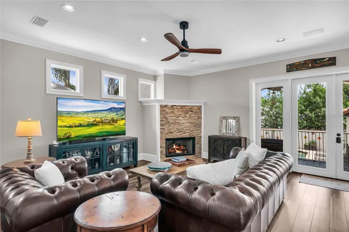 Family room with gas fireplace and French doors leading to the backporch and pool