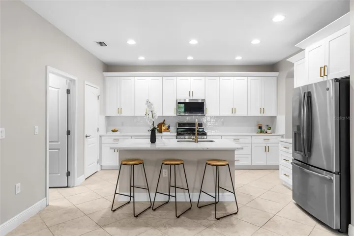 Kitchen- Quartz Counter Tops, Recessed Lighting & Island Bar Seating
