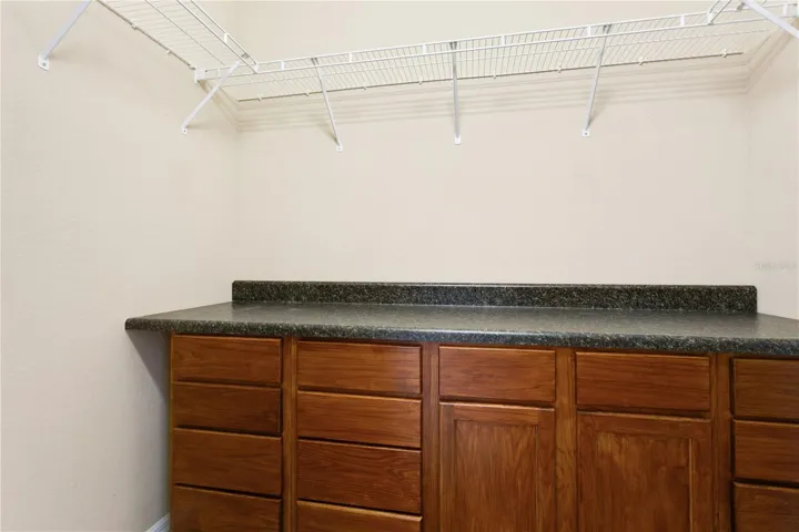 Primary walk in closet with built ins