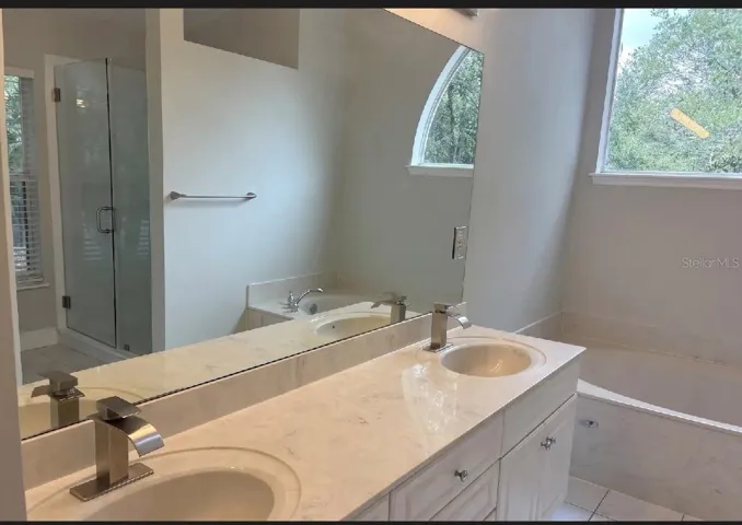 Master bathroom with bathtub and shower