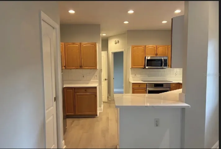 Kitchen with bar space and sliding door with large walk in pantry