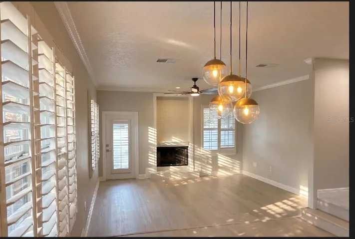 Living room with wood burning fireplace and access to back deck