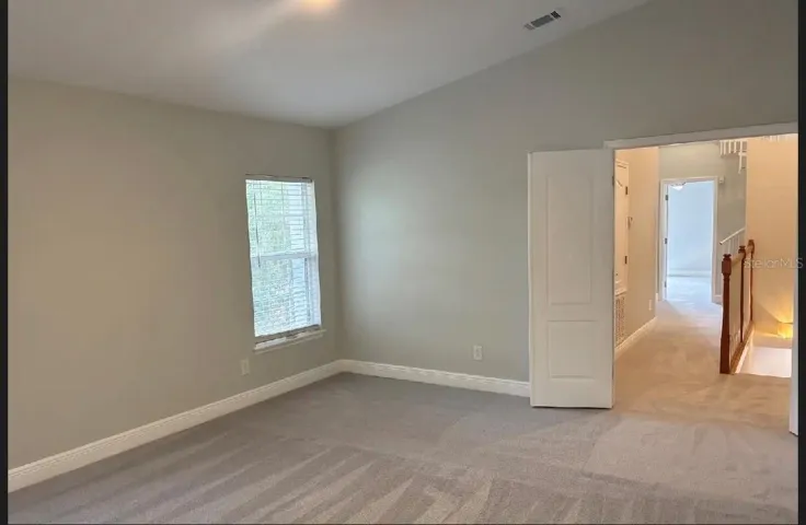 Master bedroom with French doors leading out into hallway