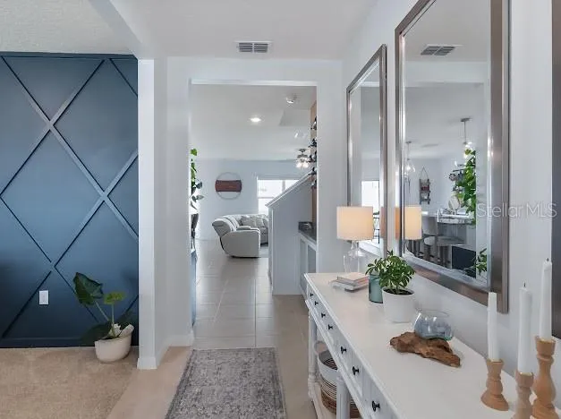 Foyer as you walk in. Room on left is currently a formal dining room with custom accent wall. Can be used as an office - flex space