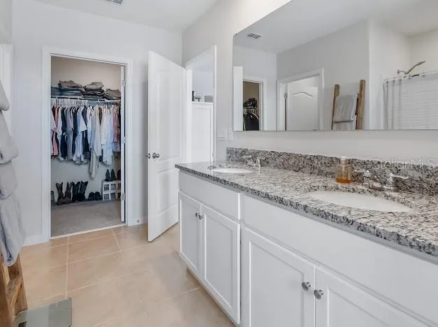 Primary bedroom en suite area which is oversized for sitting/office space, large walk in closet, great bathroom with walk in shower, double sinks and water closet