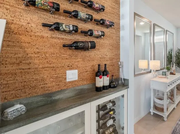 Custom cork & wine bar area added after build with counter and glass front storage area.