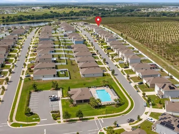 Aerial view of small community’s large pool and common area facilities.