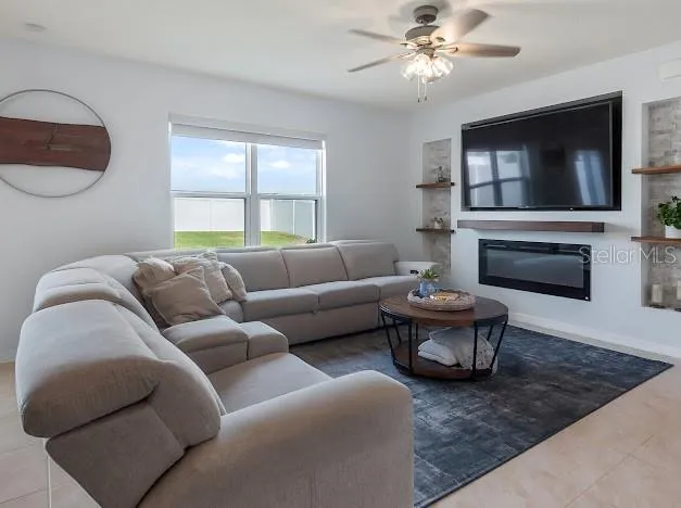 Living room off kitchen and dinette with full custom wall for shelves, large TV and electric fireplace. Shades on windows and slider are room darkening!