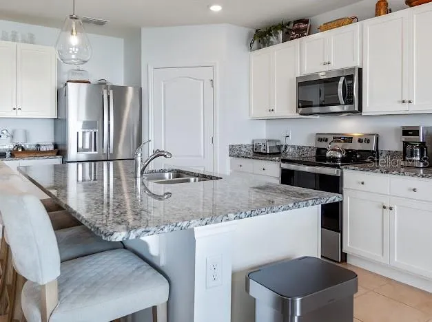 Kitchen with large eat in granite island