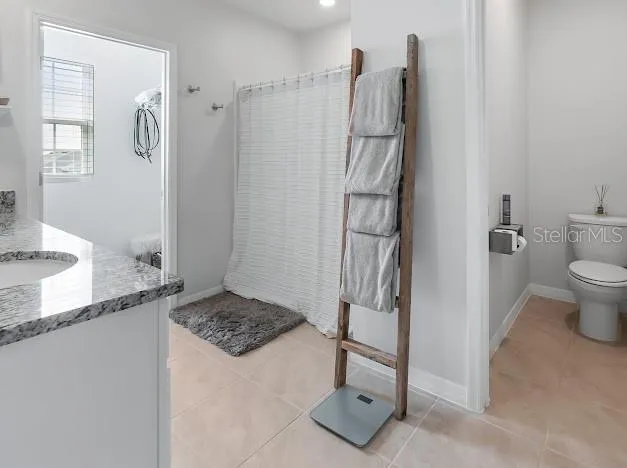 Primary bedroom en suite area which is oversized for sitting/office space, large walk in closet, great bathroom with walk in shower, double sinks and water closet