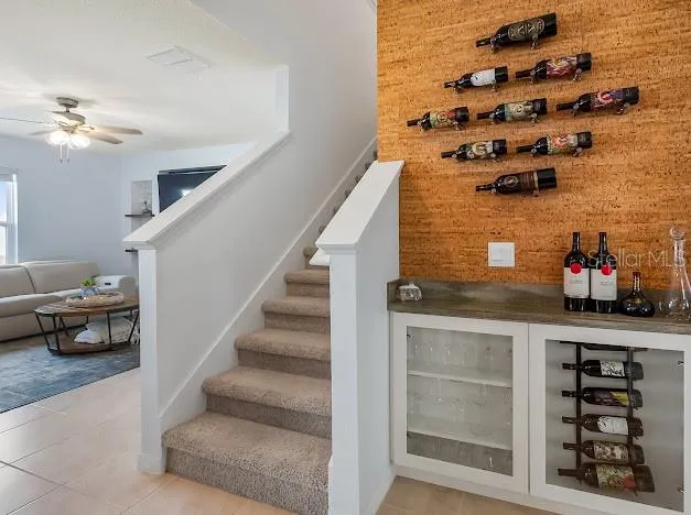 Custom cork & wine bar area added after build area of kitchen and living room area, stairs to second floor with counter and glass front storage area.