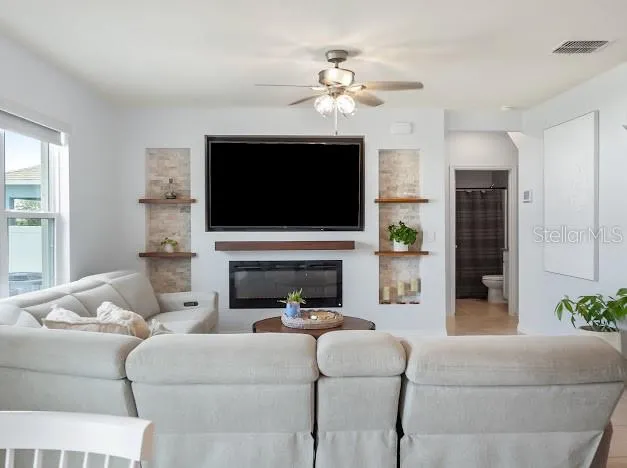 Kitchen to living room view. Custom entertainment wall with built ins and fireplace added after new build