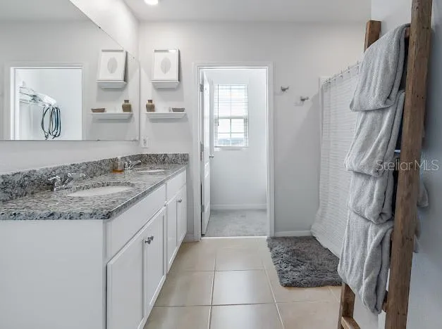Primary bedroom en suite area which is oversized for sitting/office space, large walk in closet, great bathroom with walk in shower, double sinks and water closet