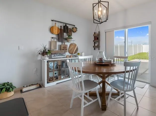 Dinette eat in kitchen area connected to living room. Sliders to back patio and yard. Custom slider shades are for room darkening