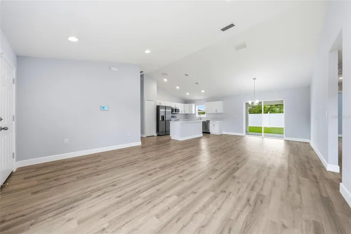 Wide-open floor plan with seamless flow between kitchen, dining, and living areas