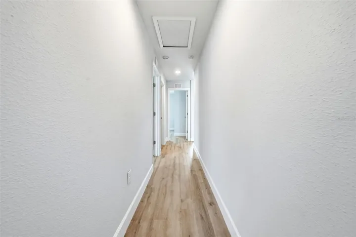 Hallway with three bedrooms and guest bathroom