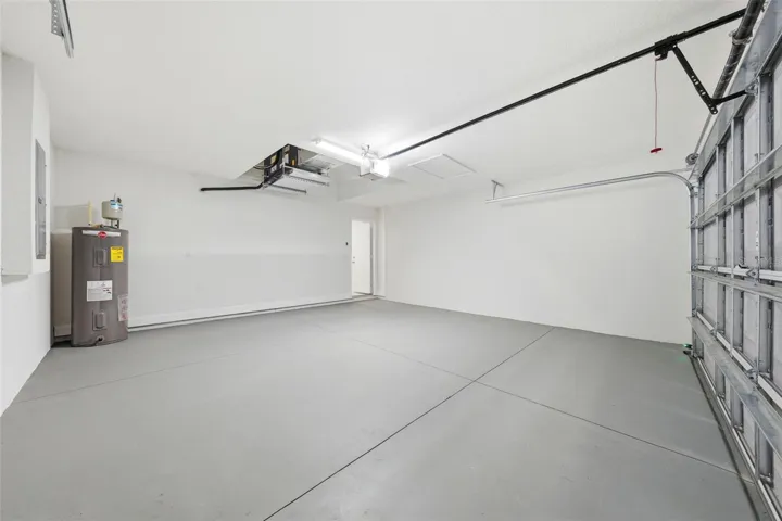 Spacious two-car garage with automatic opener and painted garage floor
