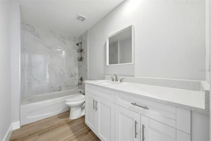 Guest bathroom with modern vanity and tub/shower combination
