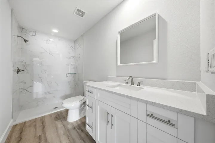 Primary ensuite bathroom featuring modern vanity cabinetry