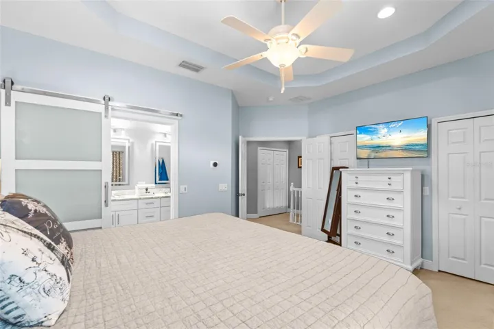 Primary bedroom with en-suite bath, walk-in closet, and standard closet.