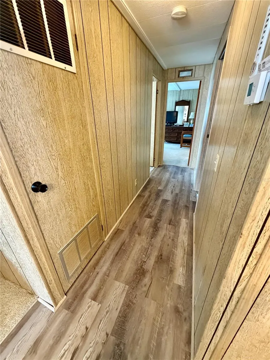 Doorway on the right is the hall bathroom, at the end of the hall you will find the primary suite, and the second bedroom is across from the hall bathroom on the left.