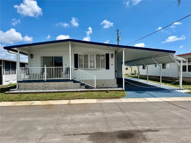 ALL NEWER CARPORT…carport extensions, gutters, and front porch roof. Painted driveway and exterior of the home.