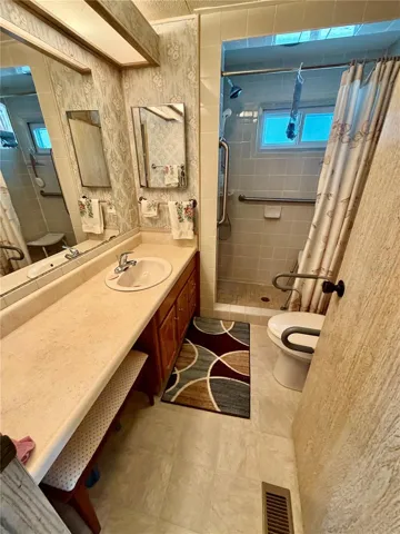 Spacious partially updated hall bathroom with a walk-in shower.