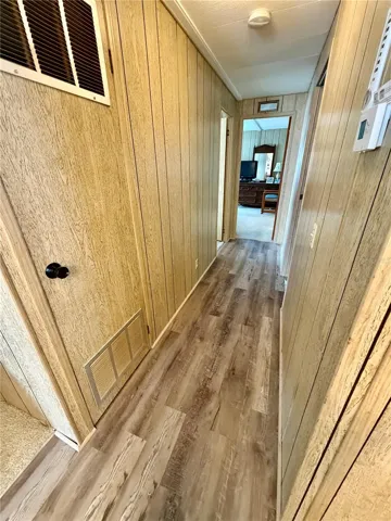 Doorway on the right is the hall bathroom, at the end of the hall you will find the primary suite, and the second bedroom is across from the hall bathroom on the left.