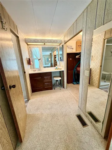 Looking into the dressing area, bath, and toilet is to the left, and across the hallway on the right is the walk-in closet